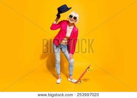 Full-body Full-legh Portrait Of Happy Granny With A Board For Skating Isolated On Vivid Yellow Backg