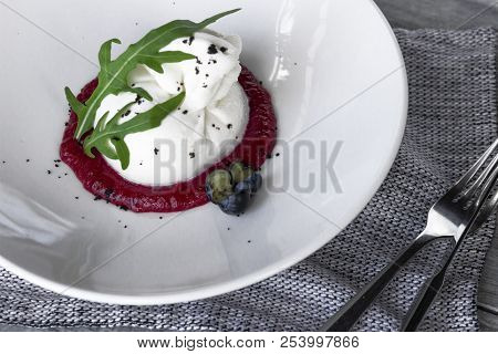 Italian Cheese Buratta Served With Berry Sauce, Arugula And Decorated With Berries