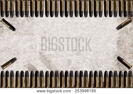 Machine Guns Bullets On Grey Background. Symmetrically