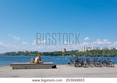 Stockholm, Sweden - July 17, 2018: Sunbathers At Hornsbergsstrand With Solna Jungfrudansen Across Th