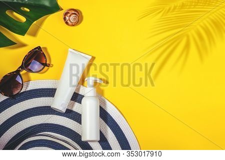 Sunprotection Objects. Womans Hat With Sunglasses And Protection Cream Spf Flat Lay On Yellow Backgr