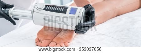 Cosmetologist In Rubber Gloves Doing Endospheres Therapy On Female Feet