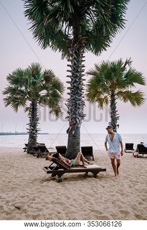Najomtien Pattaya Thailand, Couple Men And Woman Walking On The Beach During Sunrise In Pattaya Thai