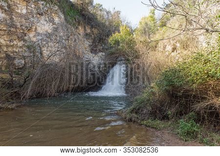 Small Waterfall Flows From A Crevice In The Mountain And Is Located In The Continuation Of The Rapid