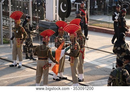 Attari, India - Febuary 8, 2020: Indian Border Security Force Folds The India Flag After The  Border
