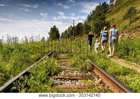 Port Baikal, Russia - July 18, 2019: People Walk Along The Circum-baikal Railroad On The Coast Of La