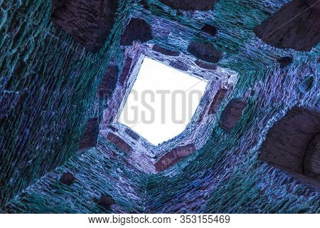 The Stone And Brick Fortress Or Castle Tower With Loopholes And Embrasure Without Roof From The Bott