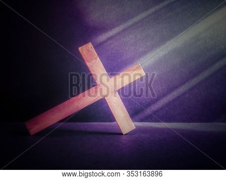Lent Season,holy Week And Good Friday Concepts - Photo Of Wooden Cross Leaning On Floor In Purple Vi