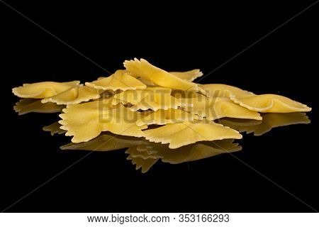 Lot Of Whole Yellow Pasta Farfalle Stack Isolated On Black Glass