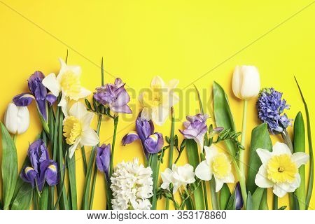Flat Lay Composition With Spring Flowers On Yellow Background