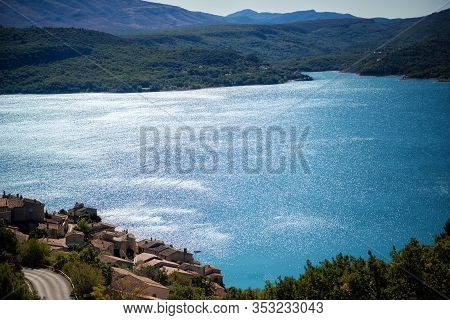 Scenic View With Blue Turquoise Water, Mountains And Roofs Of Village Around Of Lake Of Sainte-croix