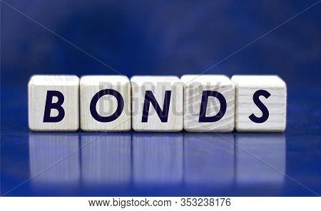 Concept Word Bonds On Cubes On A Blue Background