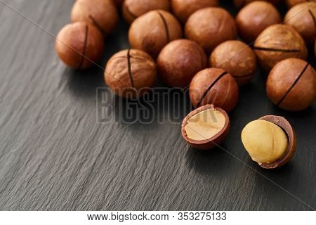 Macadam Nut Close-up On A Black Stone Background