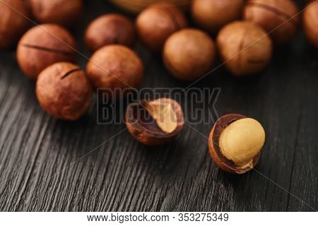 Macadam Nut Close-up On A Black Wooden Background