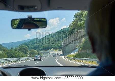 Driving A Car On A Asphalt Highway Through A Gorge