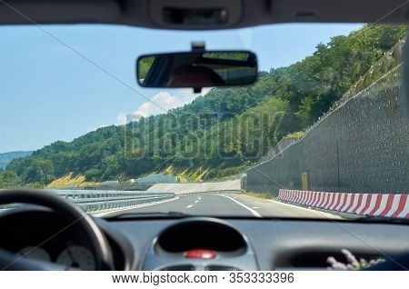 Driving A Car On A Asphalt Highway Through A Gorge