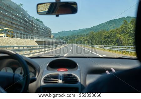 Driving A Car On A Asphalt Highway Through A Gorge