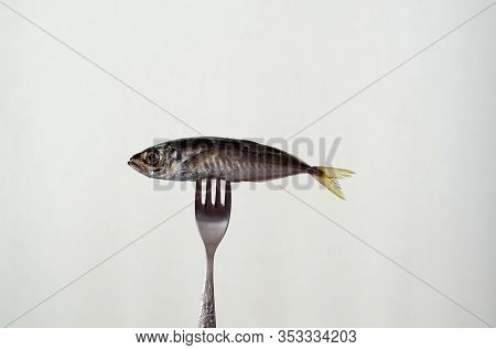 Fresh Fish On The Fork Isolated On White Background .