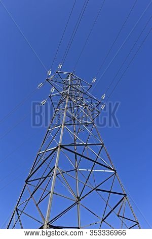 An Electricity Pylon Seen Against A Clear Blue Sky