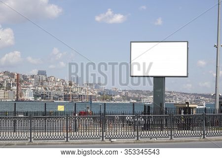 Blank White Advertising Sign Close-up. In The Background, The Bosphorus Passes In The Foreground.