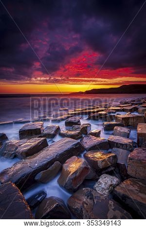 The Sky Clears After A Rain Storm Just Long Enough To Show The Deep Red And Purple Clouds Over The S