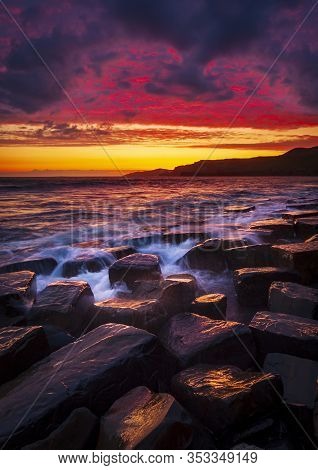 The Sky Clears After A Rain Storm Just Long Enough To Show The Deep Red And Purple Clouds Over The S