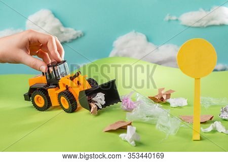 Kid Playing With Toy Truck And Collecting Trash With Scoop
