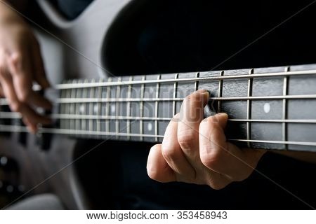 Bass Guitar Player Hand Closeup, Lesson And Practice Theme. Playing On Bass Electric Guitar, Live Mu
