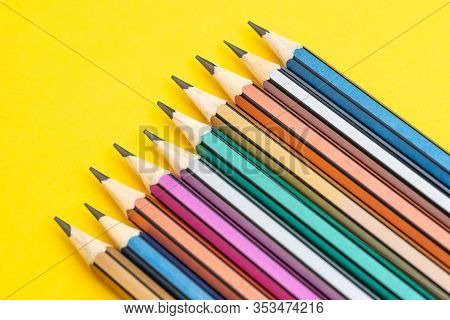 Soft Focus On Colorful Pencils On Solid Yellow Background With Copy Space Using As Writing Ideas, Va