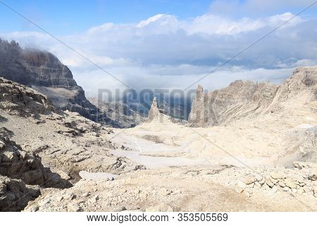 Mountain Castelletto Superiore In Brenta Dolomites With Snow Fields And Clouds, Italy
