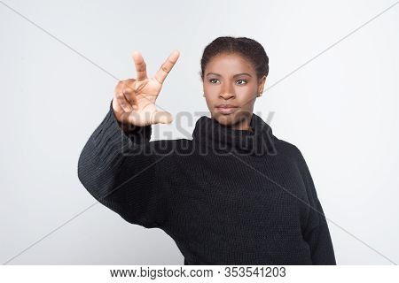 Front View Of Calm Woman Using Virtual Screen. Attractive Young Lady Pressing Something On Imaginary