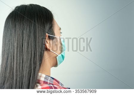 Rear View Of Woman In Mask Because Of Air Pollution And Epidemic In City. Protection Against Virus,