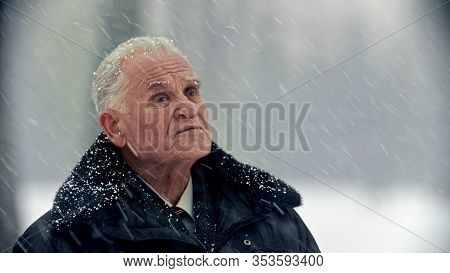 An Old Gray-haired Man Under The Snowfall