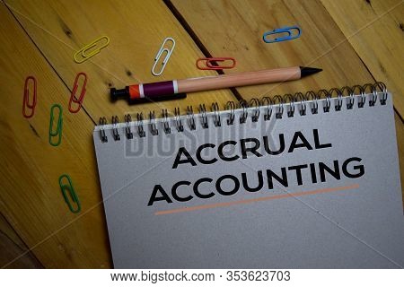 Accrual Accounting Write On A Book Isolated On Wooden Background.