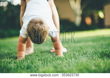 Small Boy Staying On His Hands On The Grass
