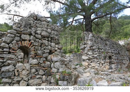 view on Chimera church  ruin  in forest near Yanartash natural vents with perpetual flames. Famous tourist Lician way in Turkey