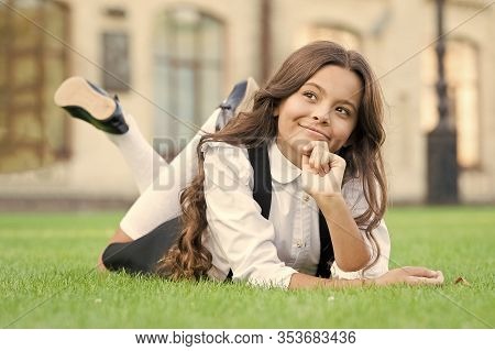 School Is Closed. Little Child Relax On Green Grass During Break Time. Small Girl Enjoy School Break