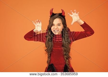 Halloween Costumes Designed After Supernatural Figures. Little Devil. Little Girl Red Horns Celebrat
