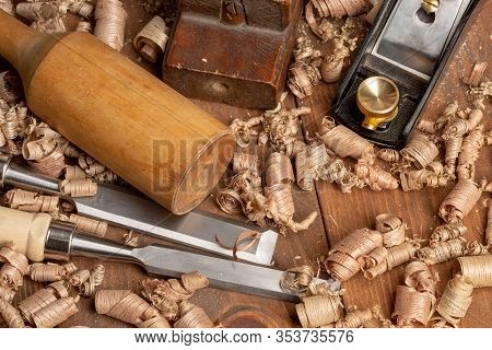 Chisel And Small Block Plane With Wood Shavings