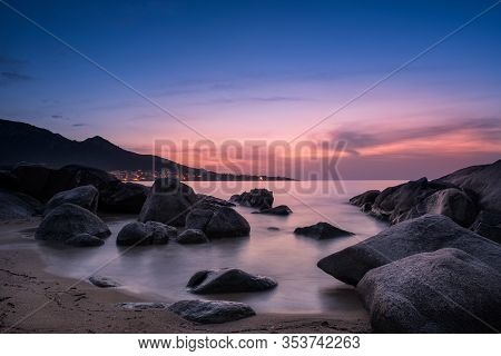Night Falling Over Beach And Village Of Algajola In Corsica