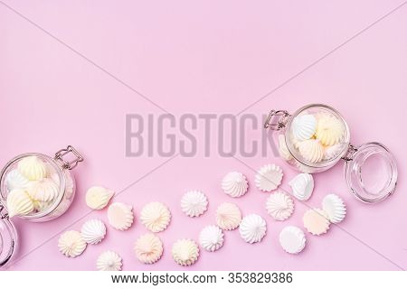 Small Meringue And Flass Jars With Small Meringues On Pink Background Flat Lay Top View Copy Space
