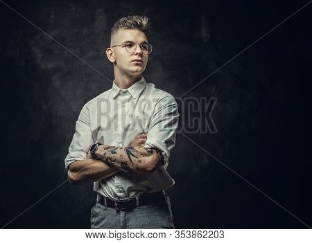 Young Student Guy, With Tattoos On His Hand, Wearing White Shirt, Glasses And Watches, Posing In A D