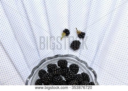 Half A Round Crystal Vase With Fresh Blackberries On White In Fine Polka Dot Fabric Folded With Fold