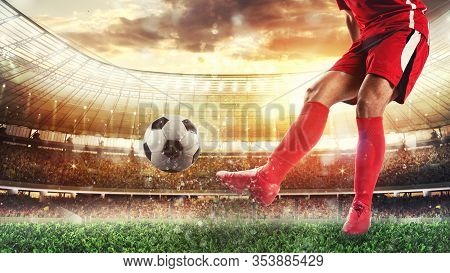 Soccer Scene At The Stadium With Player In A Red Uniform Kicking The Ball