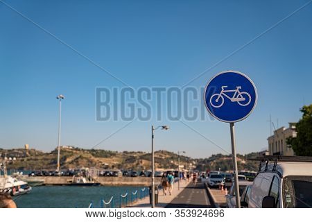 Bike Path Area And Blue Bike Sign In Pedestrian Area Near The Bay