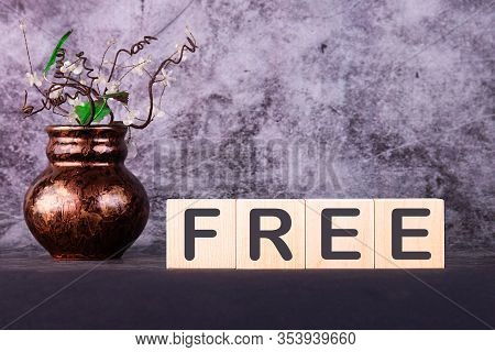 Word Free Made With Wood Building Blocks On A Gray Background