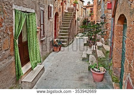 Pitigliano, Grosseto, Tuscany, Italy: Old Alley With Ancient Houses And Plants In The Picturesque Me