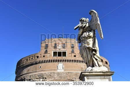 Castel Santangelo And Marble Angel From Ponte Sant Angelo With Blue Sky. Rome, Italy.