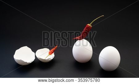 Chili Peppers And Fresh Chicken Eggs With A Broken Hollow Shell On The Atomic Surface. Beginning A D
