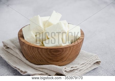 Homemade Indian Paneer Cheese Made From Fresh Milk And Lemon Juice, Diced In A Wooden Bowl On A Gray